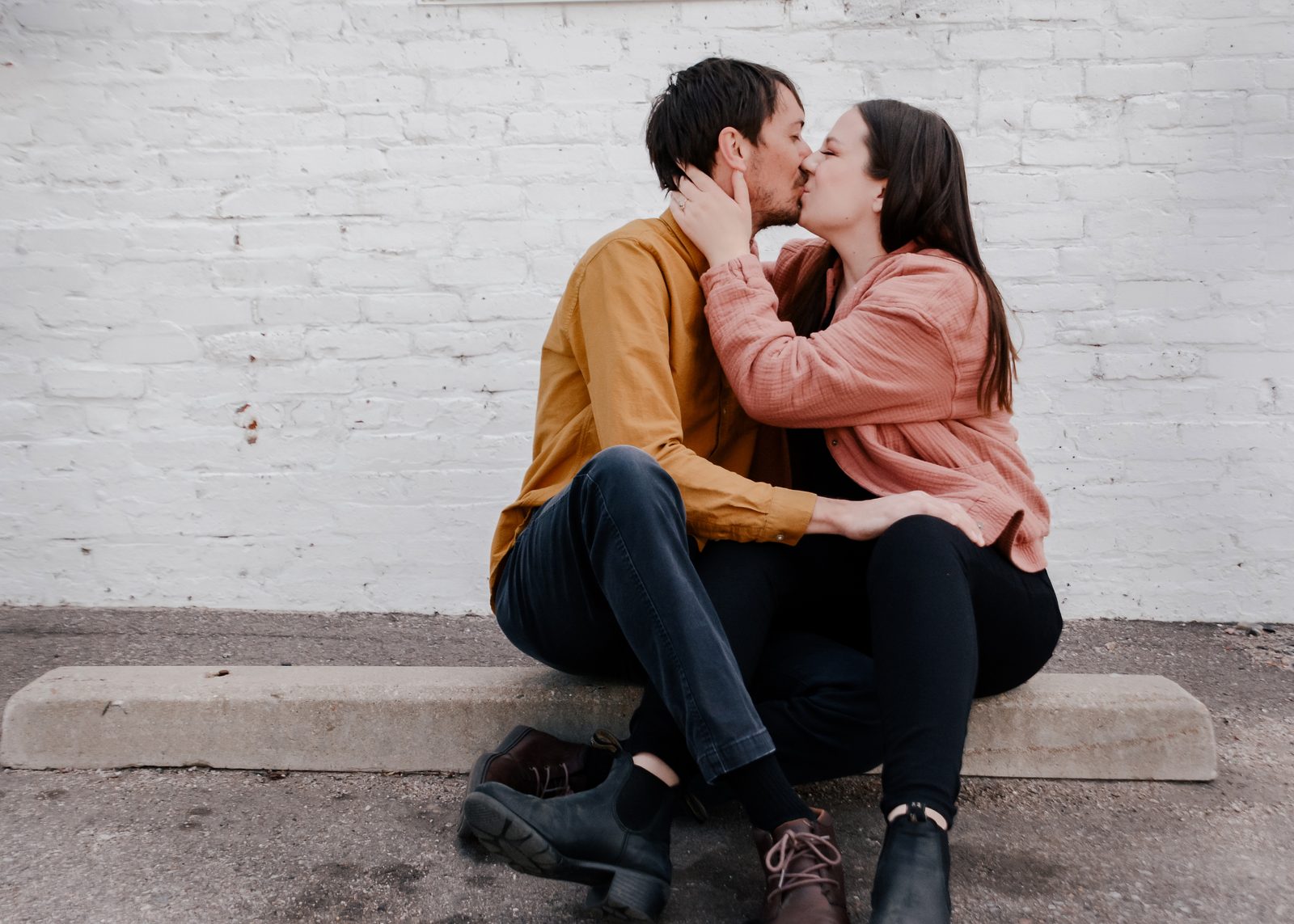 Couple by a brick wall