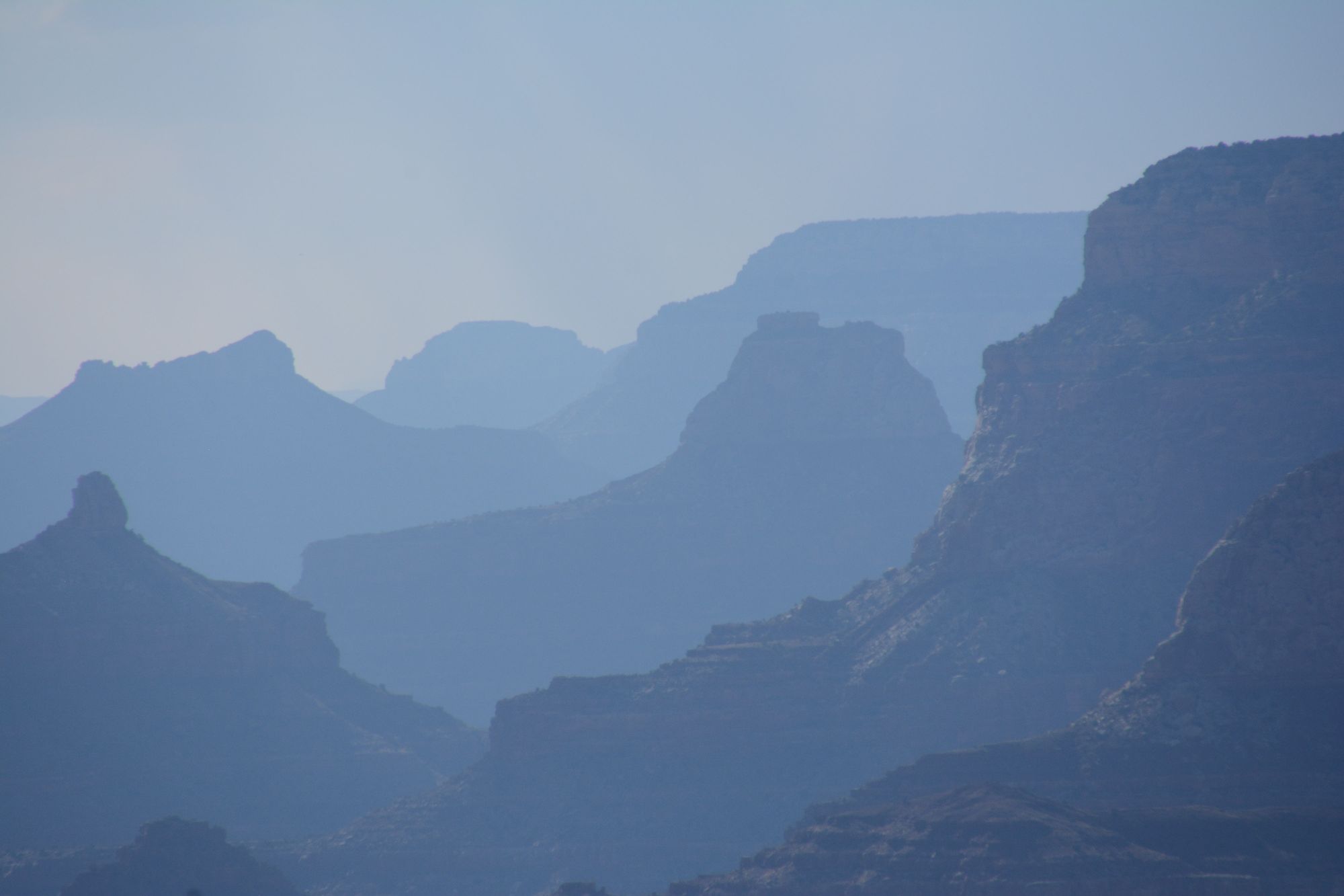 Layered canyon ridges in blue haze