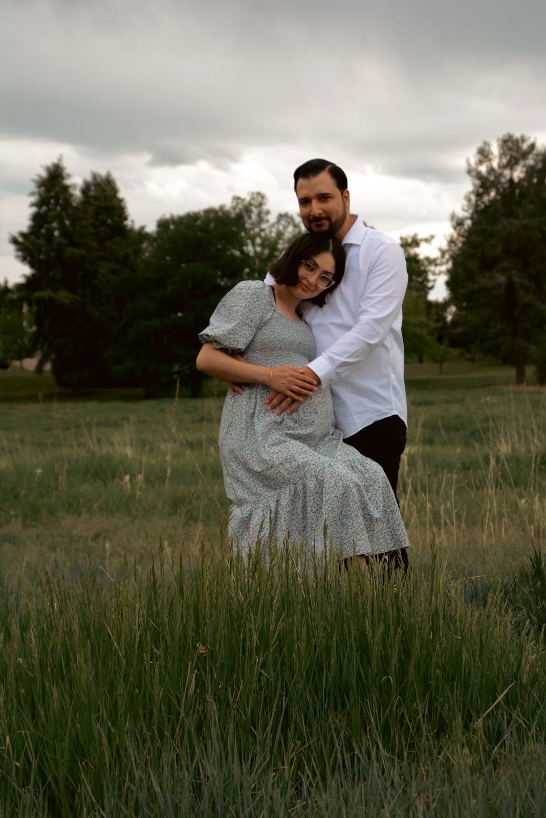 Expecting couple in a field